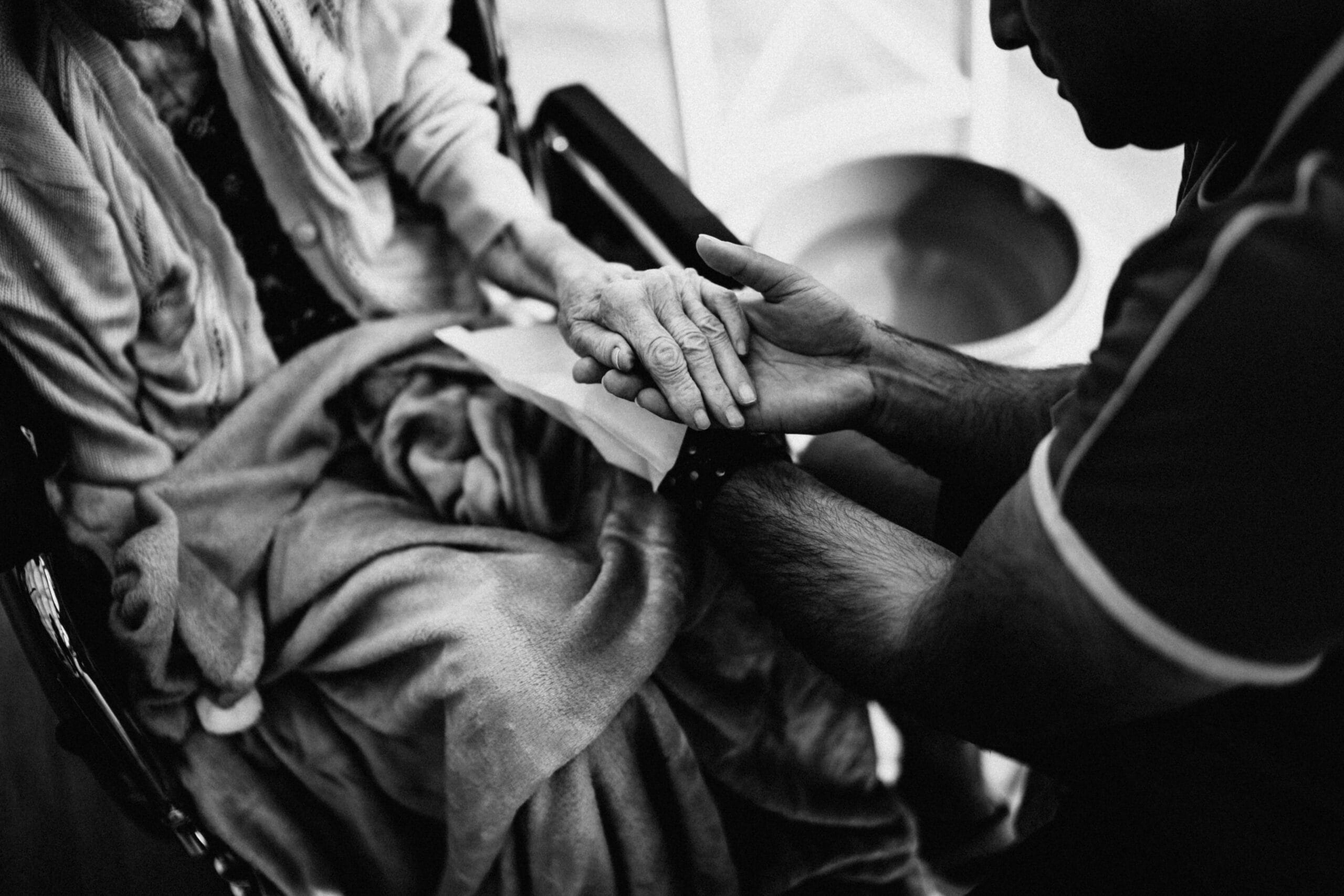 Hands held in a moment of care